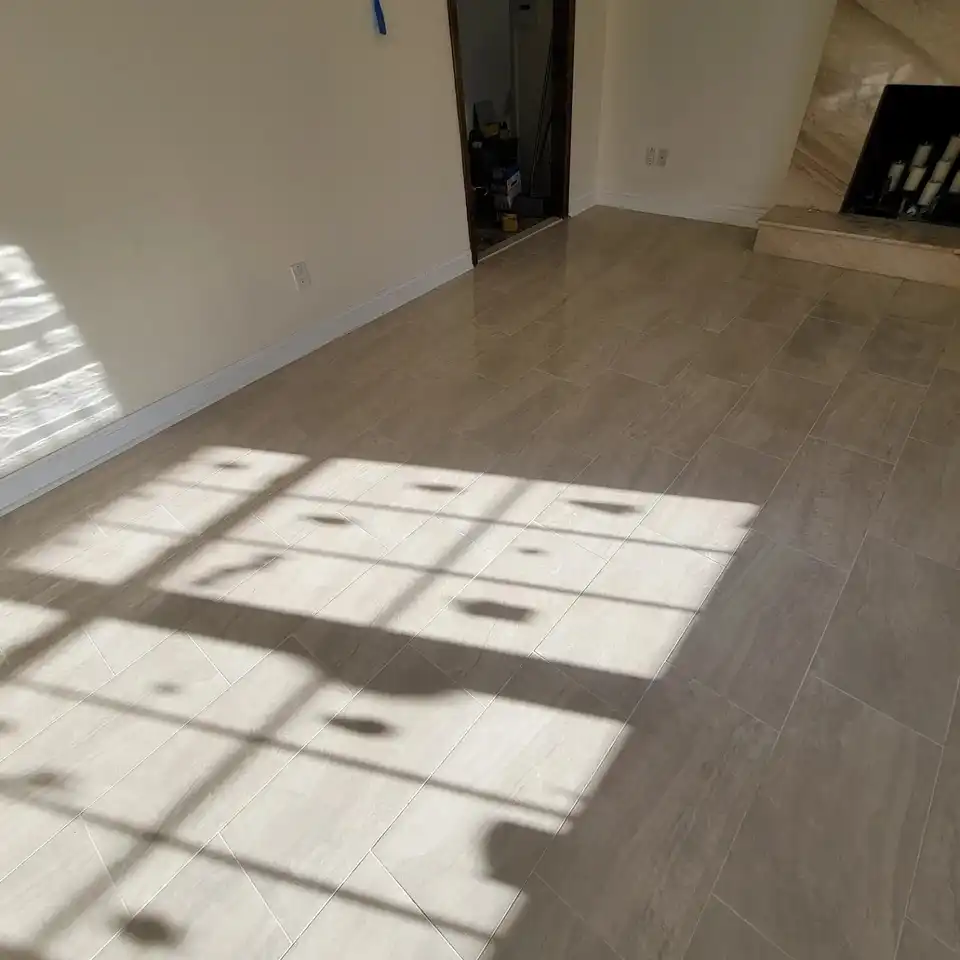 Wood-look porcelain plank floor across a living room with window light
